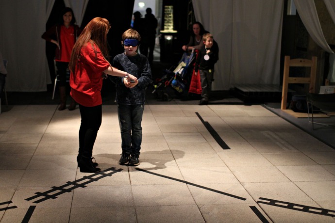 A picture of a teenager taking part in a blindfolded experiment at the Science Museum.